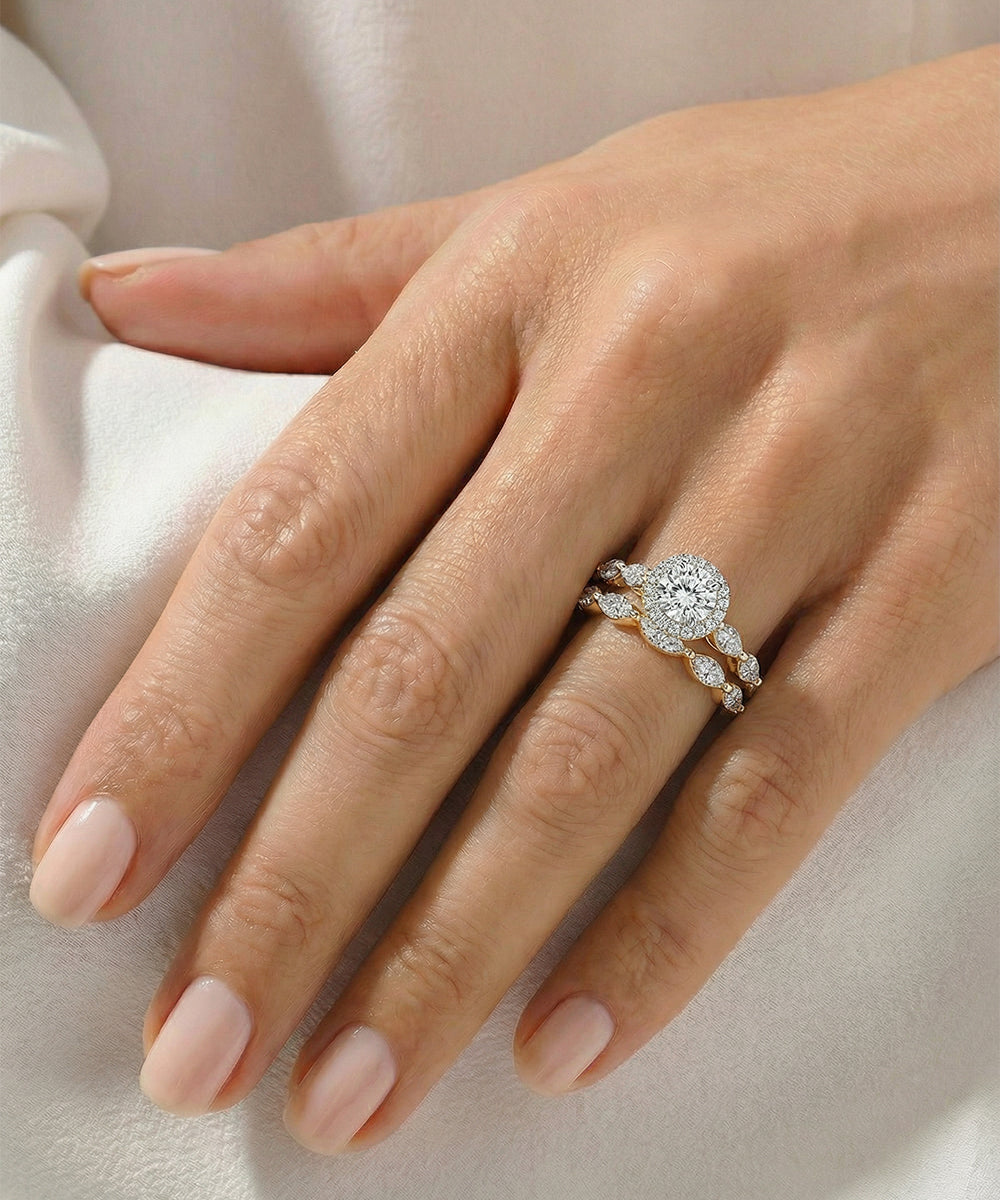 Hand wearing a diamond ring on a light background