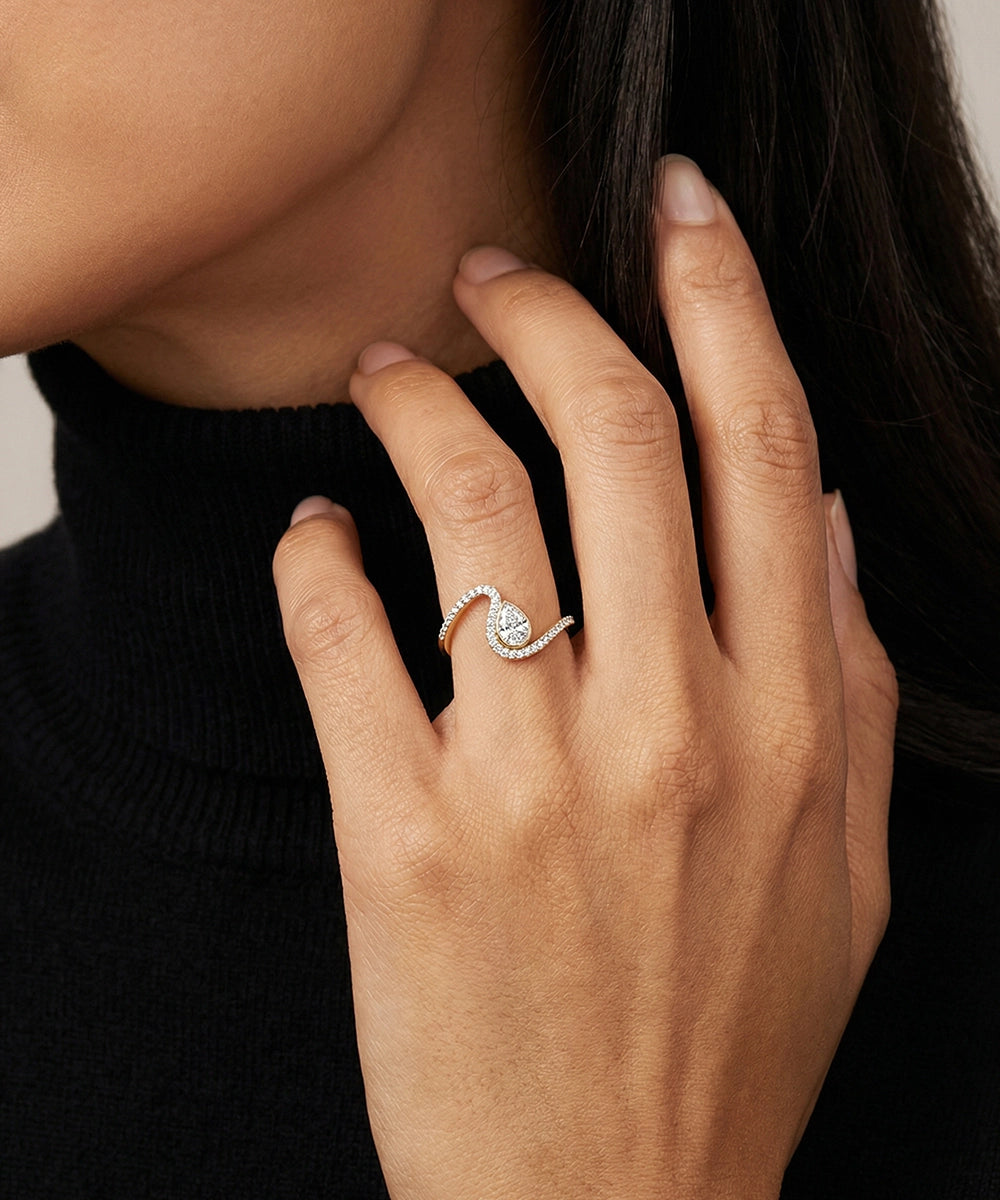 Close-up of a hand wearing a diamond ring with a blurred background