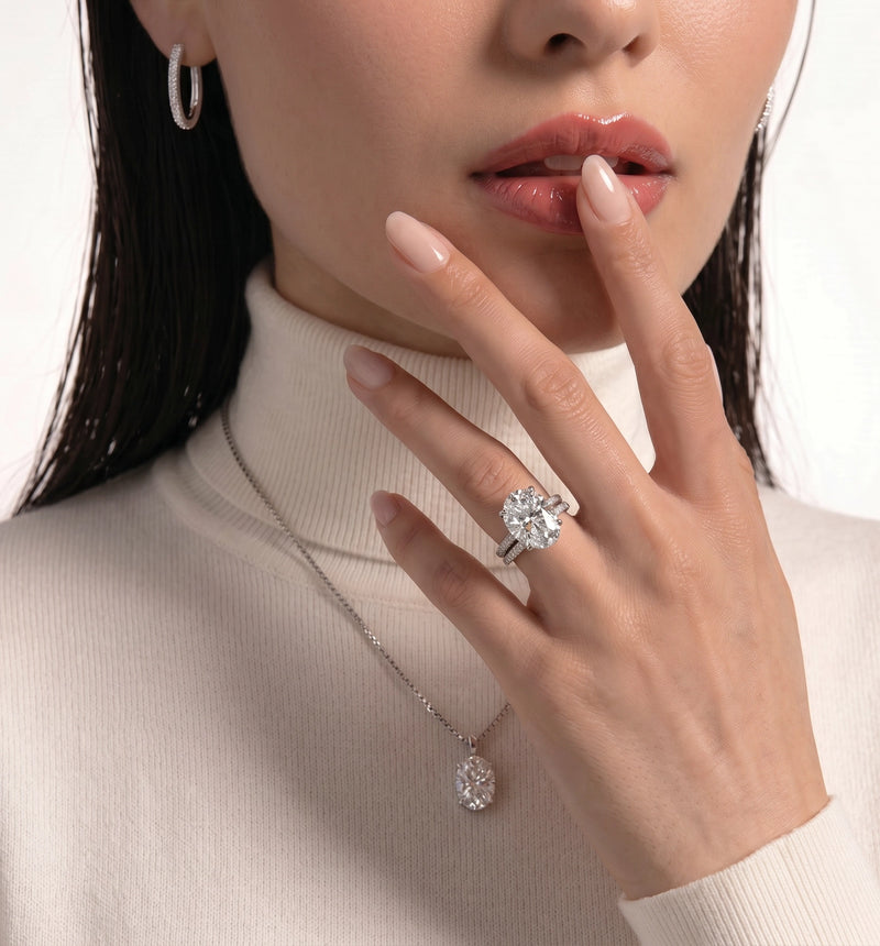 Close-up of a woman wearing a diamond ring and necklace on a white background
