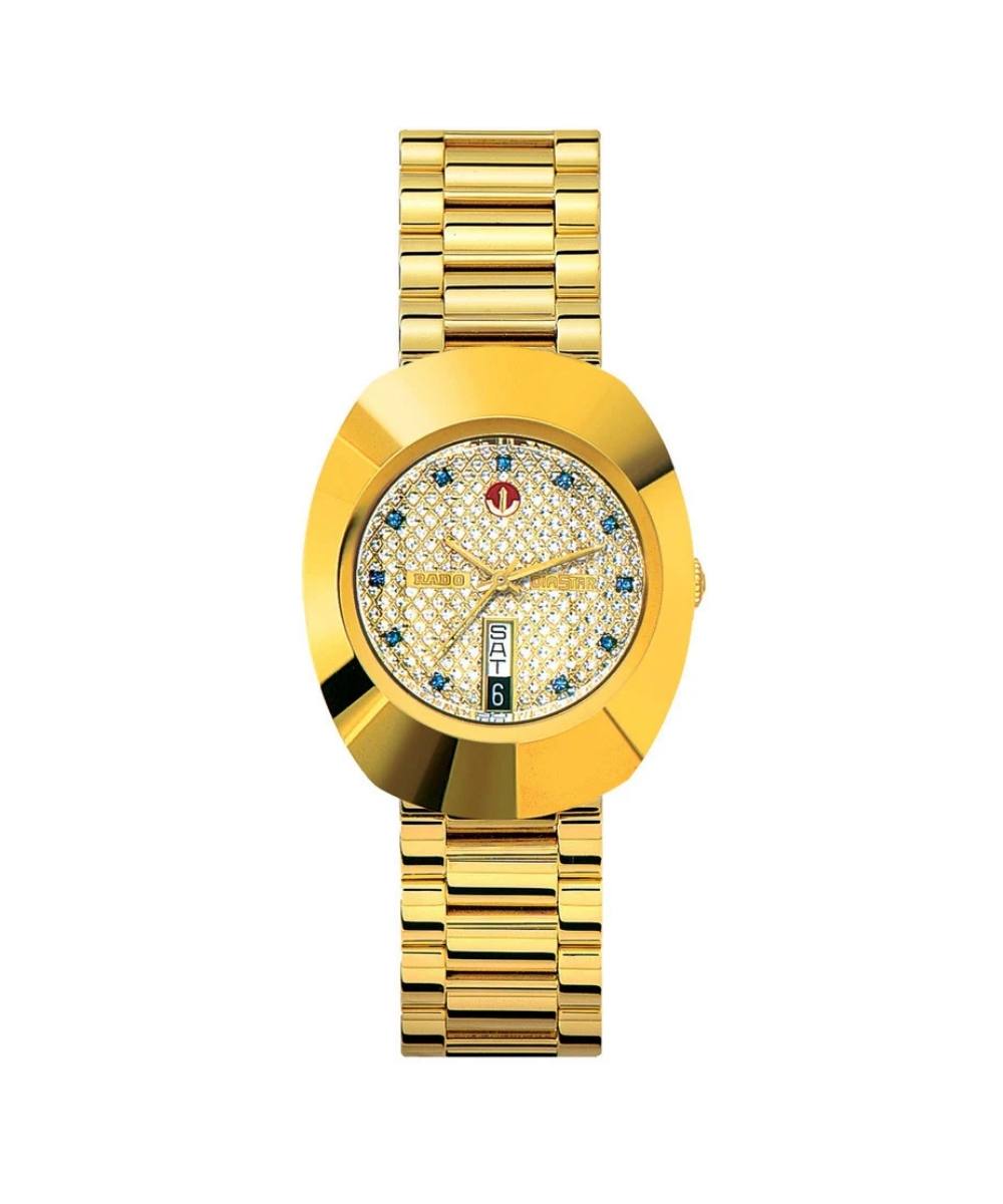 Gold wristwatch with a decorative face on a white background