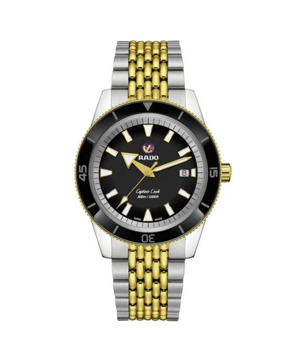 Watch with a black face, gold and silver metal band on a white background