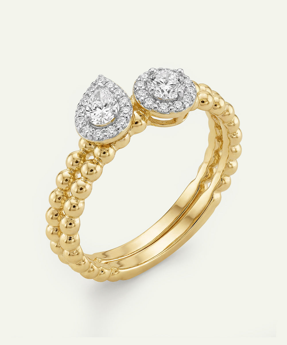 Gold ring with two diamond stones on a white background