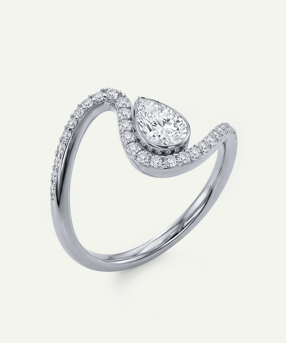 Diamond ring with a pear-shaped center stone on a white background