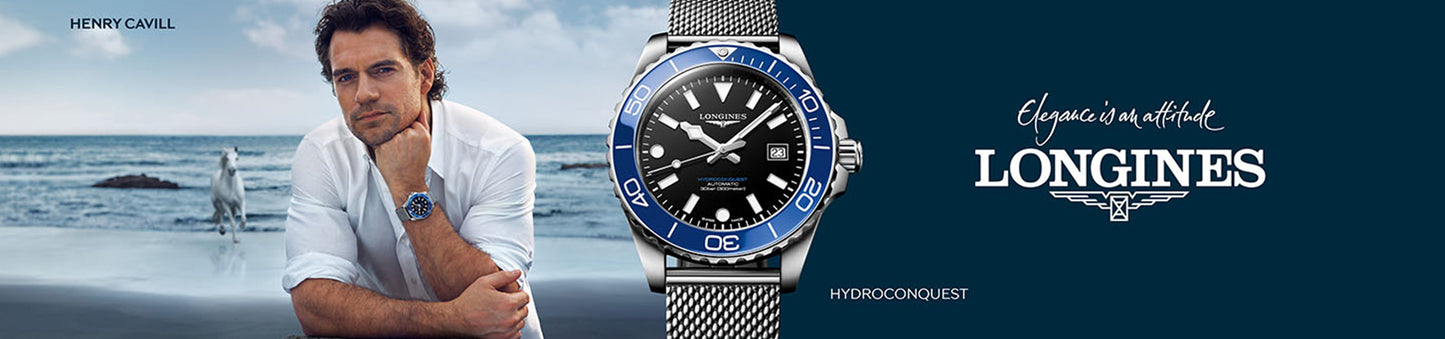 Man on a beach with a Longines watch displayed prominently, featuring the brand's logo.