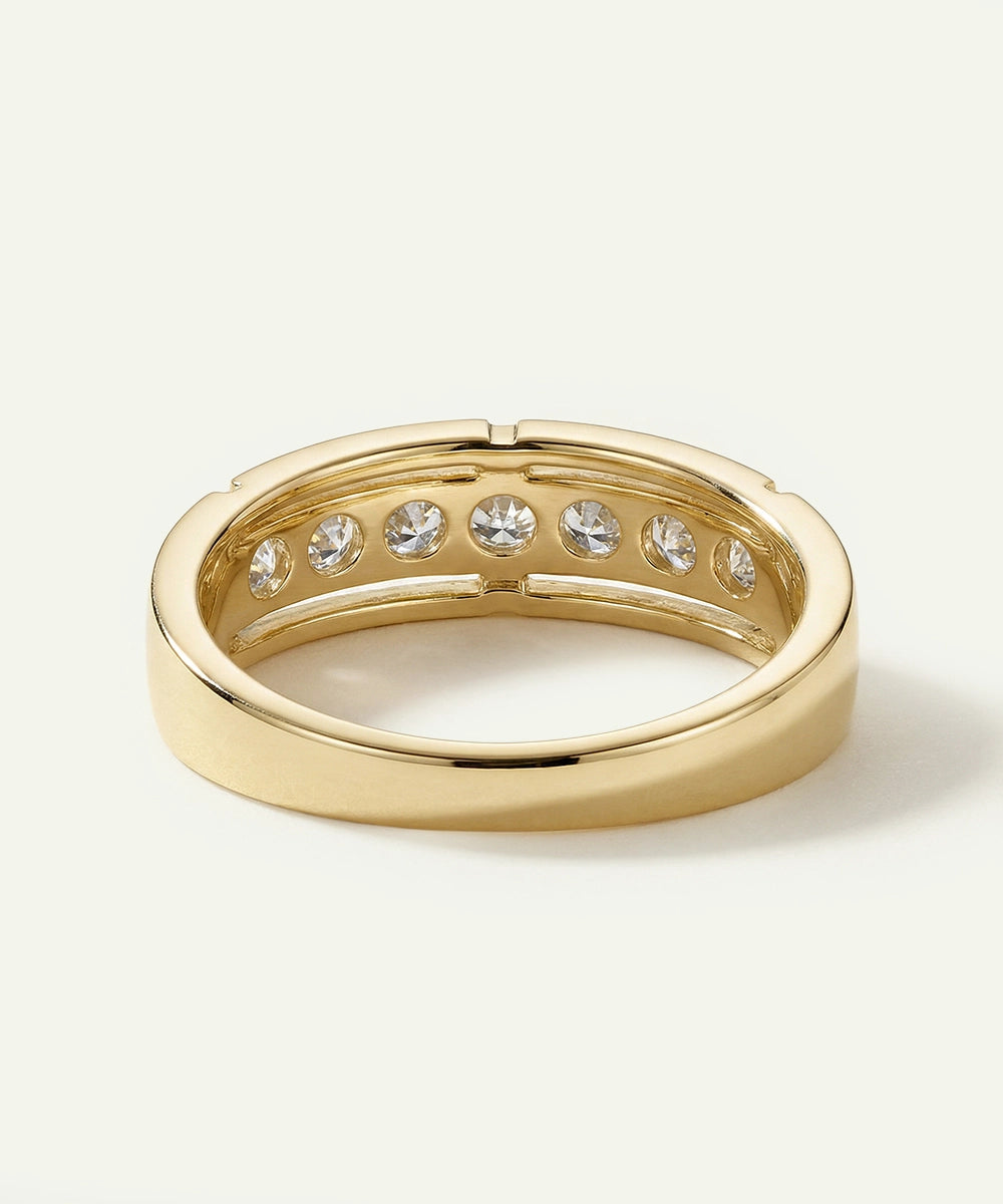 Gold ring with embedded diamonds on a light background