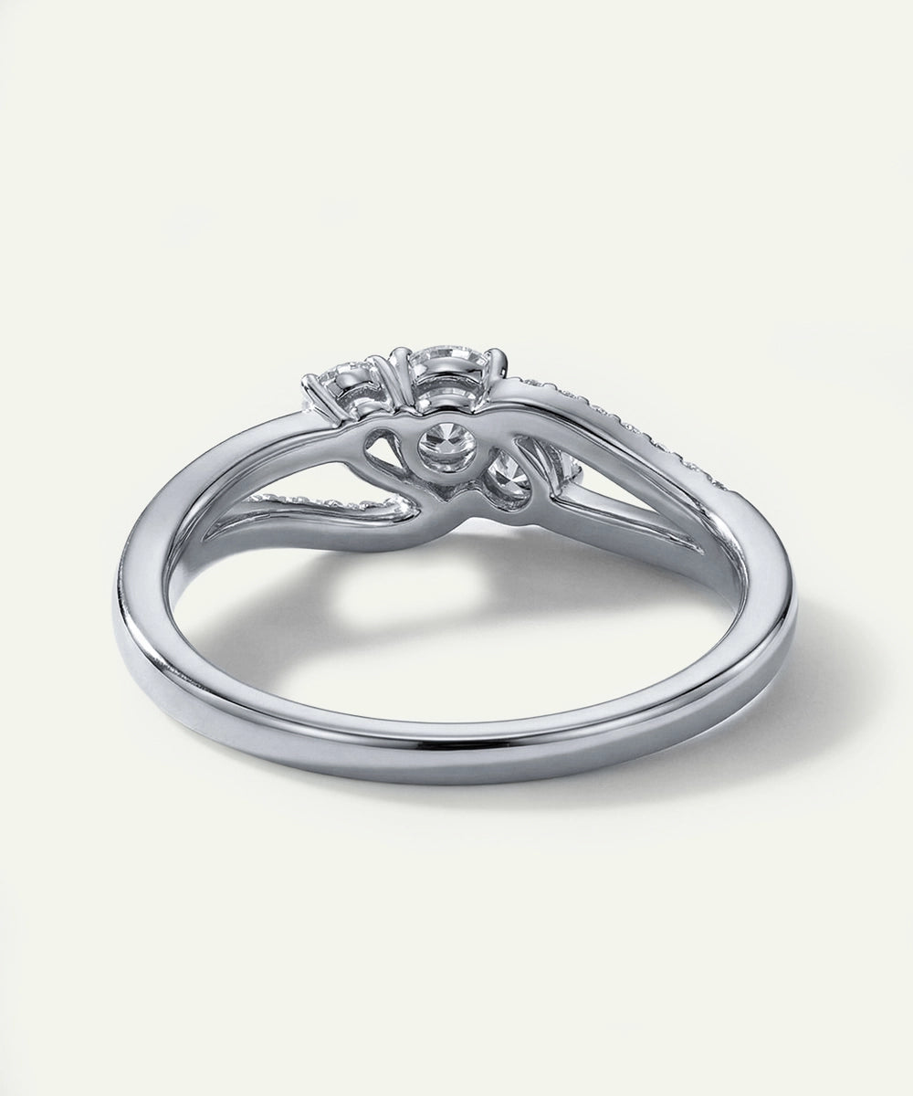 Silver ring with diamond accents on a white background