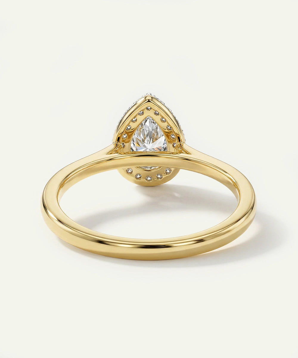 Gold ring with a diamond on a light background