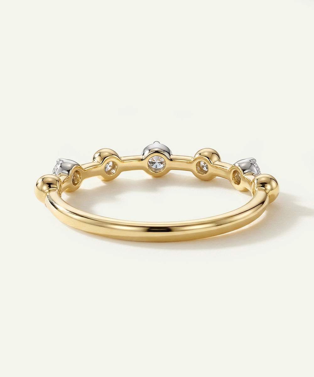 Gold ring with embedded diamonds on a white background
