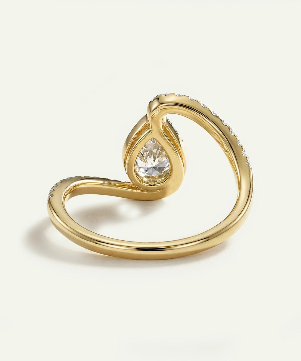 Gold ring with a diamond on a light beige background