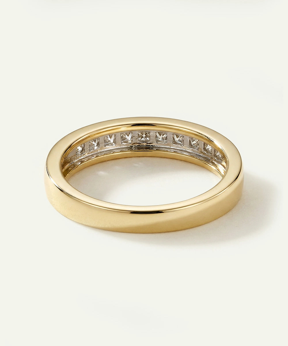 Gold ring with diamond stones on a white background