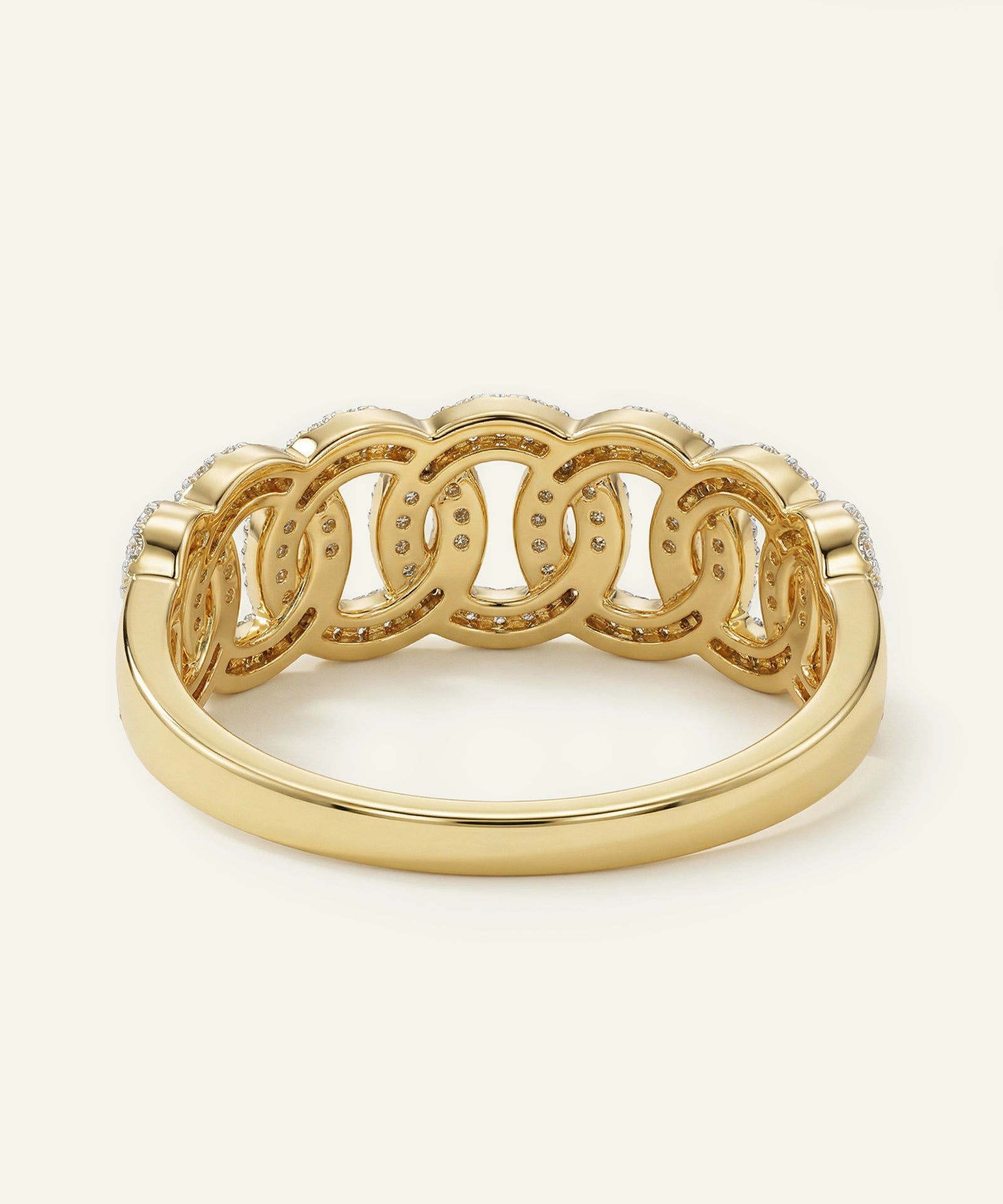 Gold ring with interlocking design on a white background