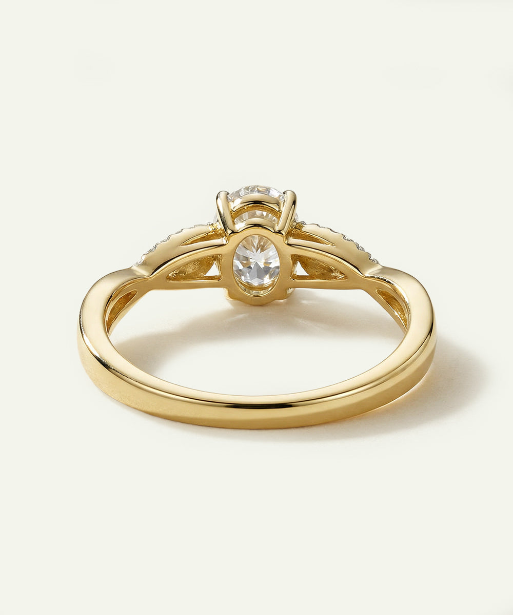 Gold ring with a diamond on a light beige background