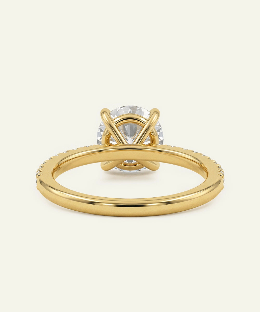 Gold ring with a diamond on a light gray background
