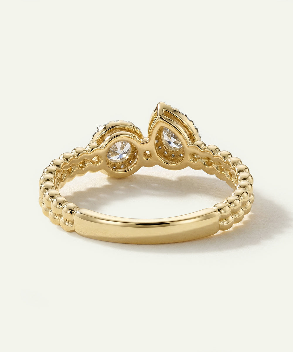 Gold ring with diamond accents on a light background