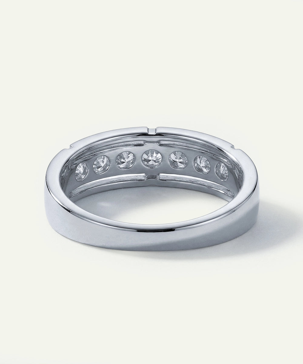 Silver ring with embedded diamonds on a white background