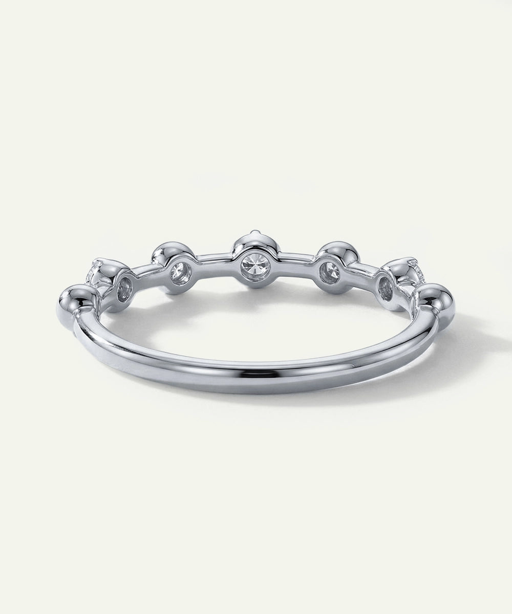 Silver ring with small diamonds on a white background