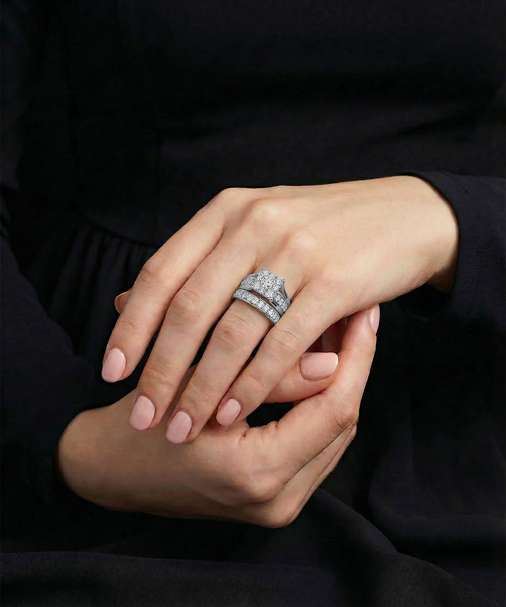 Close-up of a hand wearing a diamond ring on a dark background