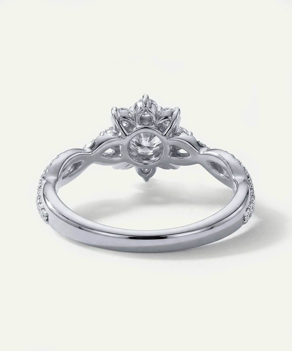 Silver ring with intricate design on a white background