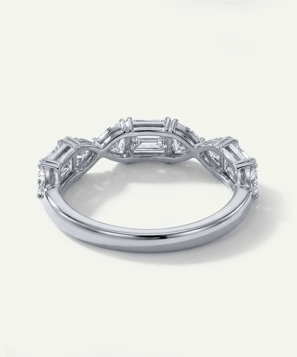 Silver ring with diamond accents on a white background