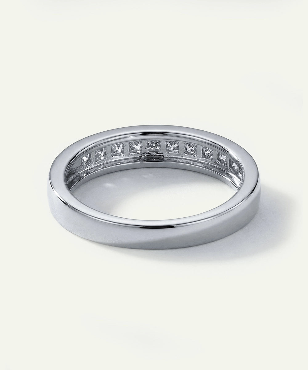 Silver ring with embedded diamonds on a white background
