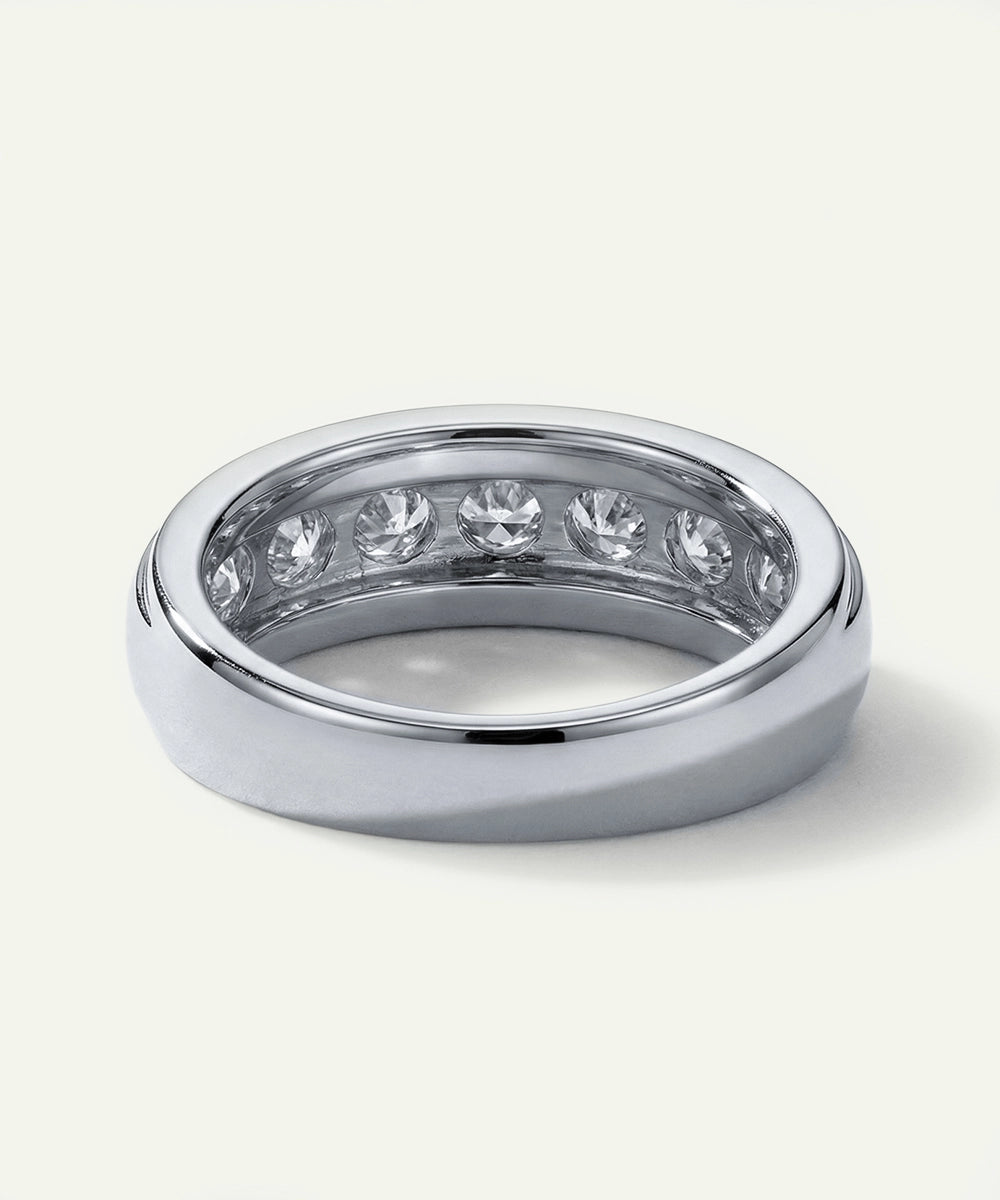 Silver ring with embedded diamonds on a white background