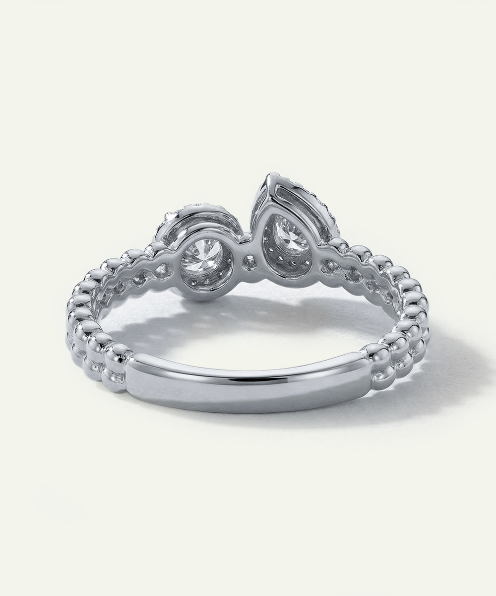 Silver ring with intricate design on a white background