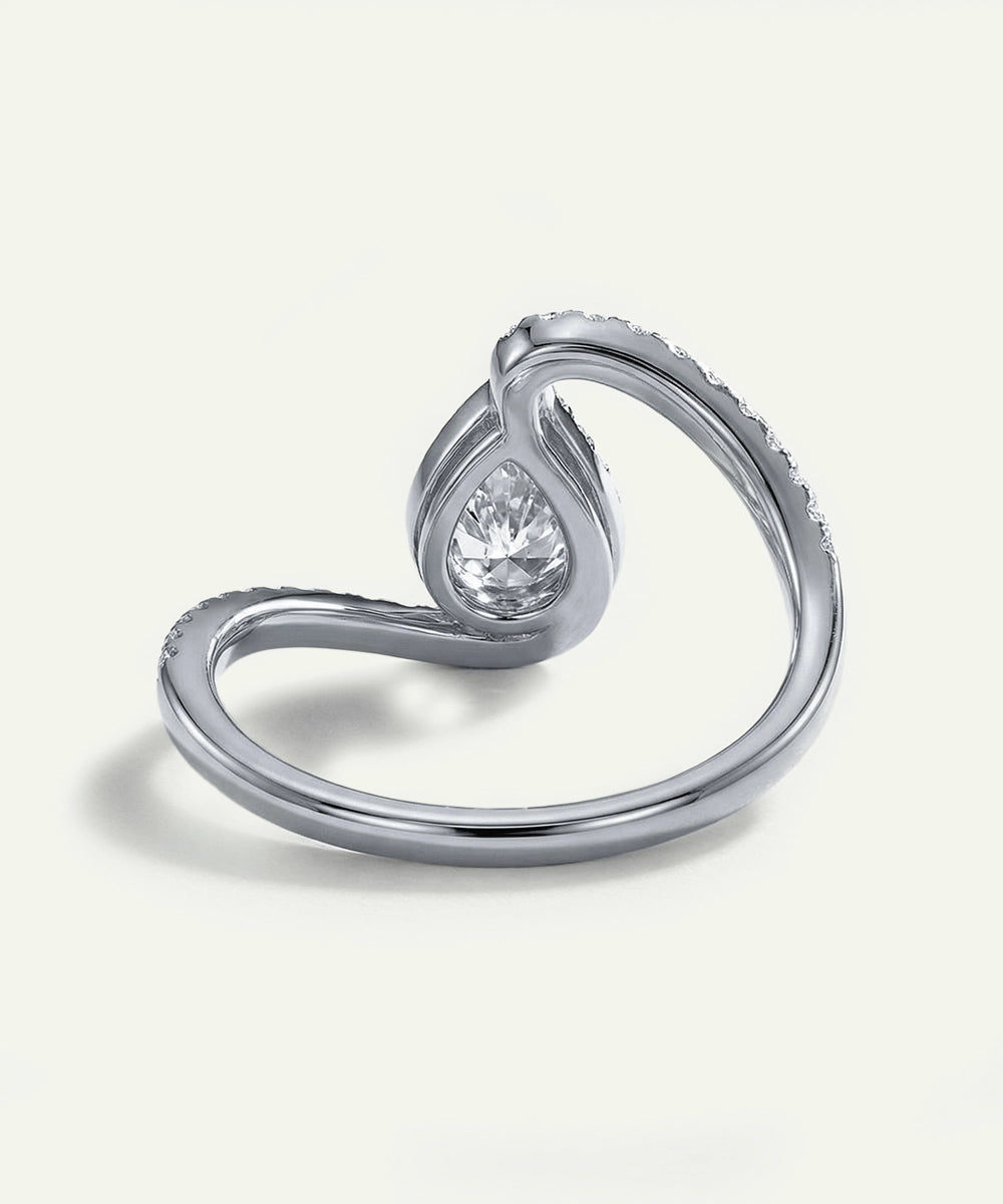 Silver ring with a diamond on a light gray background