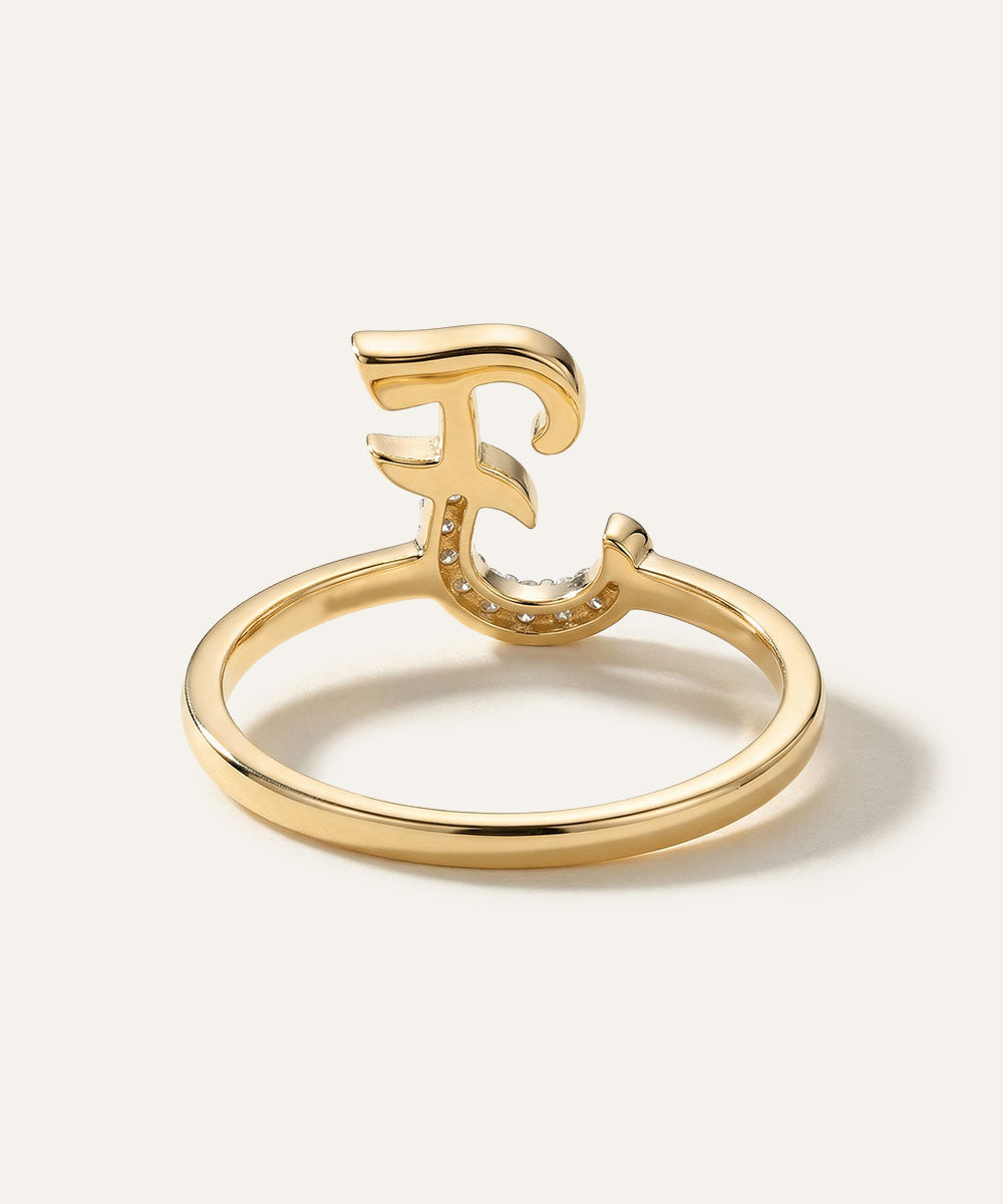 Gold ring with a unique design on a white background