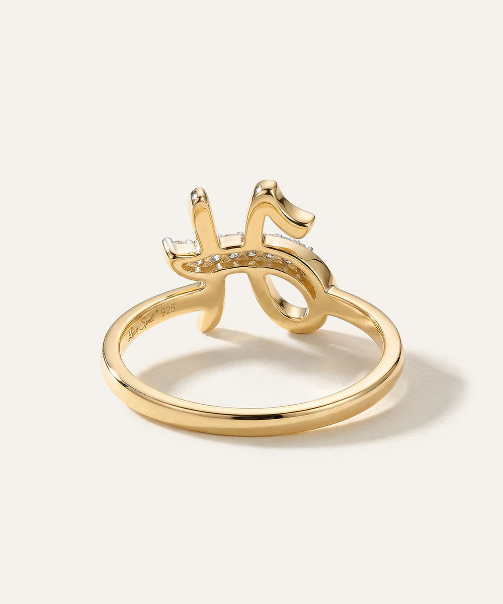 Gold ring with a unique design on a white background