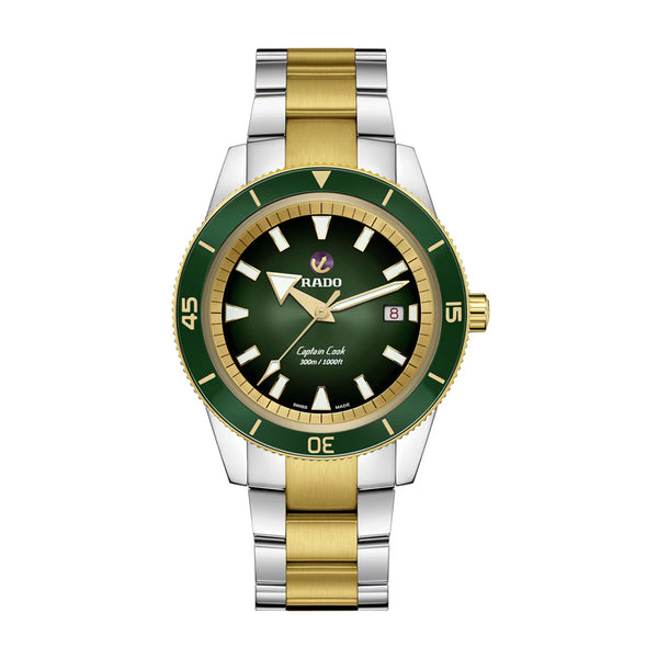 Two-tone watch with green face and gold accents on a white background