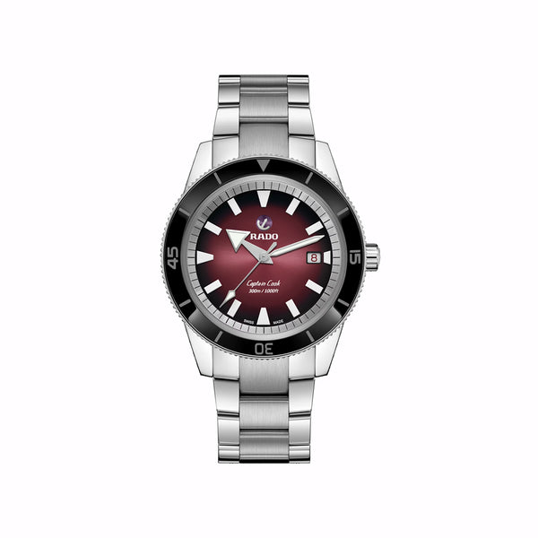 Silver watch with a red face on a white background