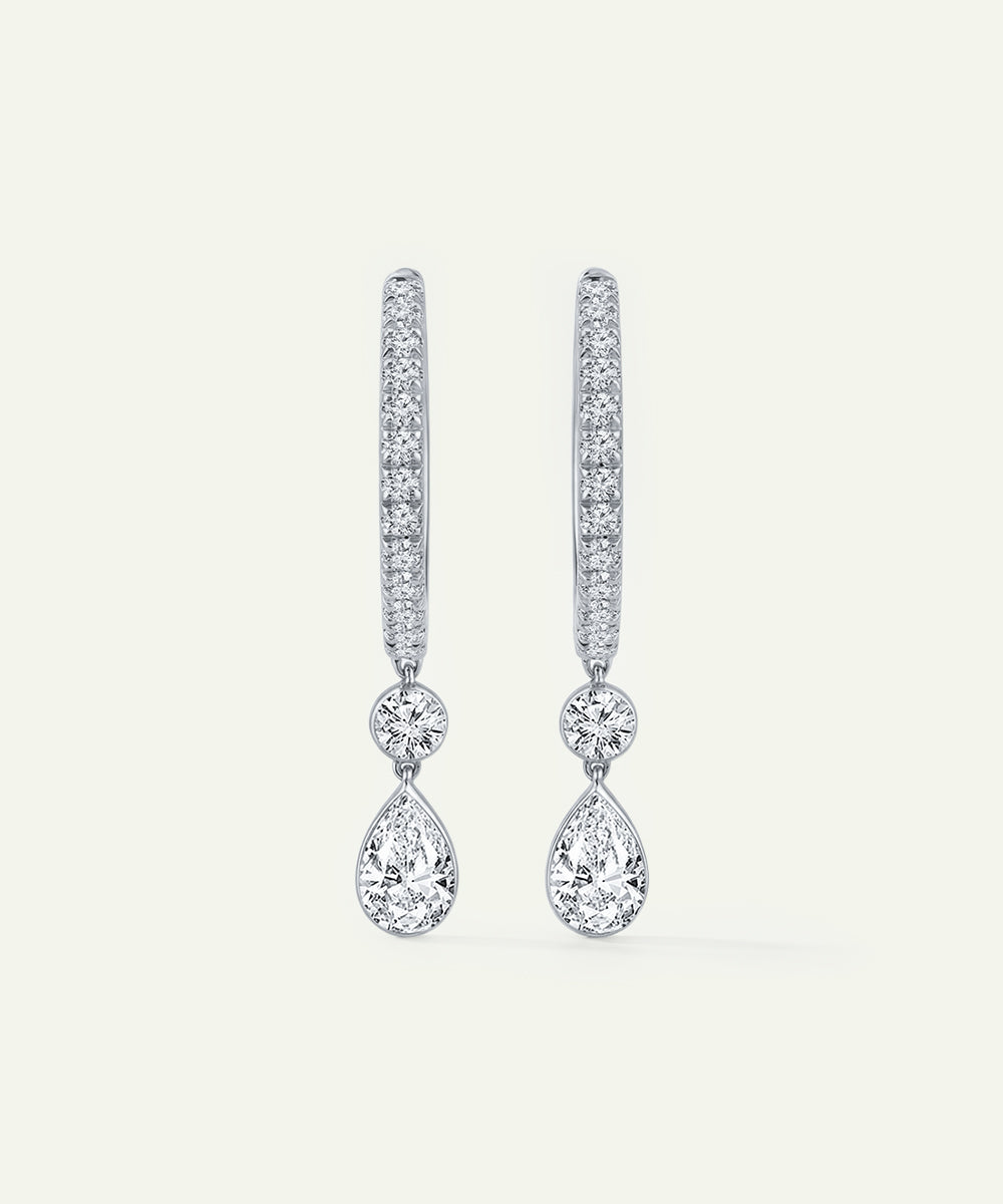 Pair of diamond earrings on a light gray background