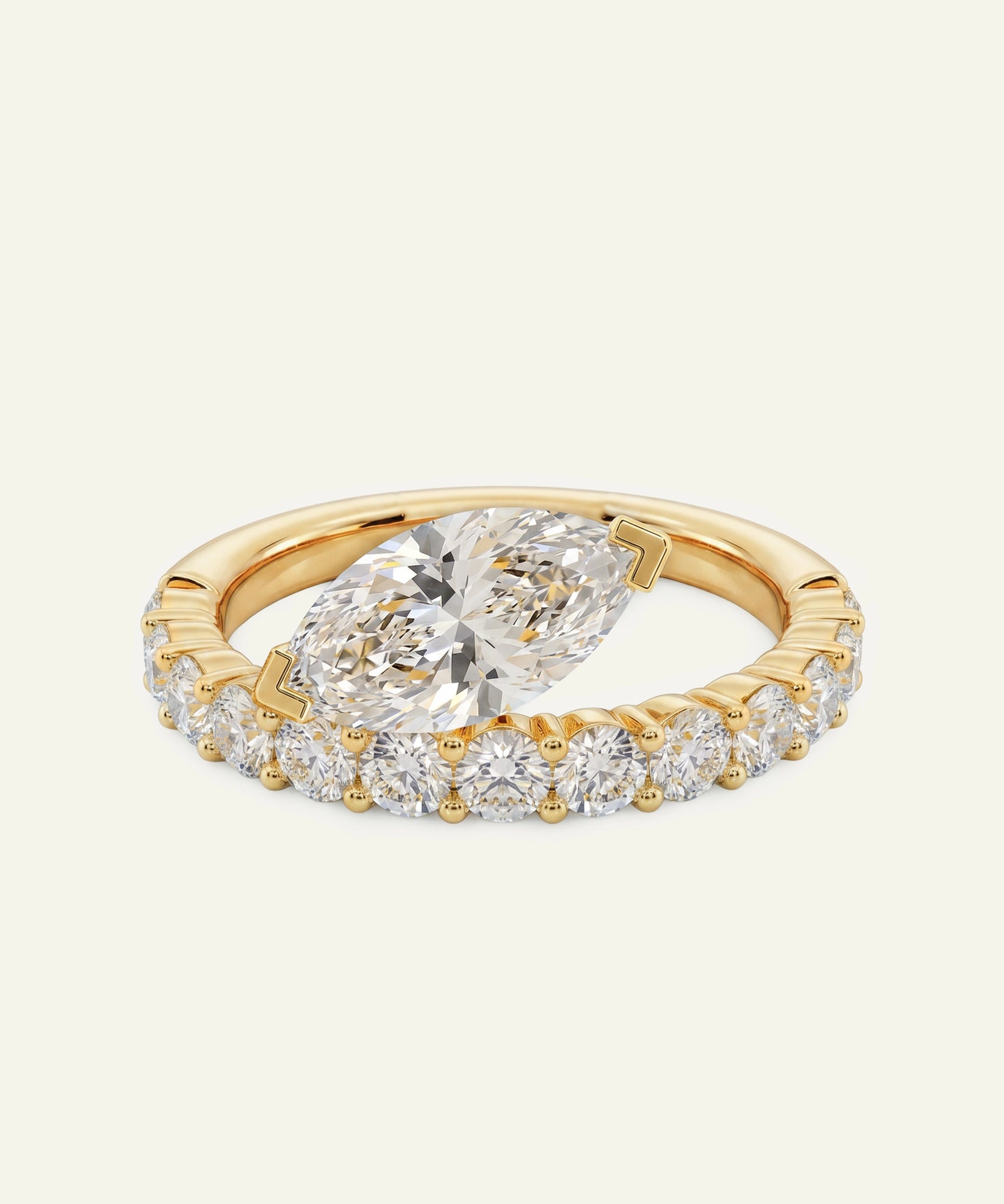 Gold ring with a large diamond and smaller diamonds on a light beige background