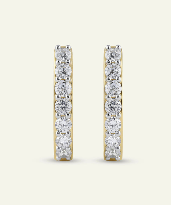 Pair of diamond hoop earrings on a white background