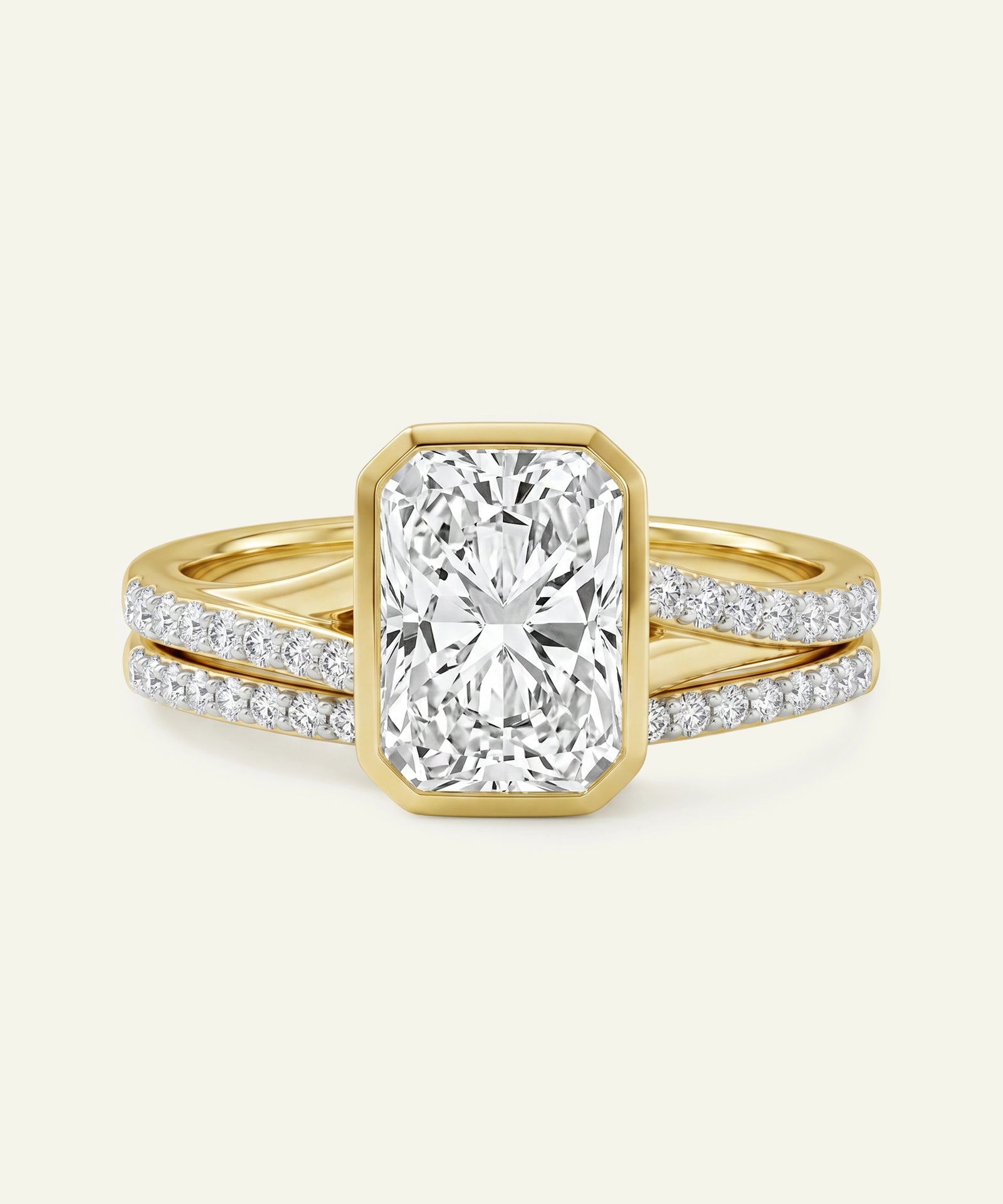 Gold ring with a large diamond and smaller diamonds on the band against a white background