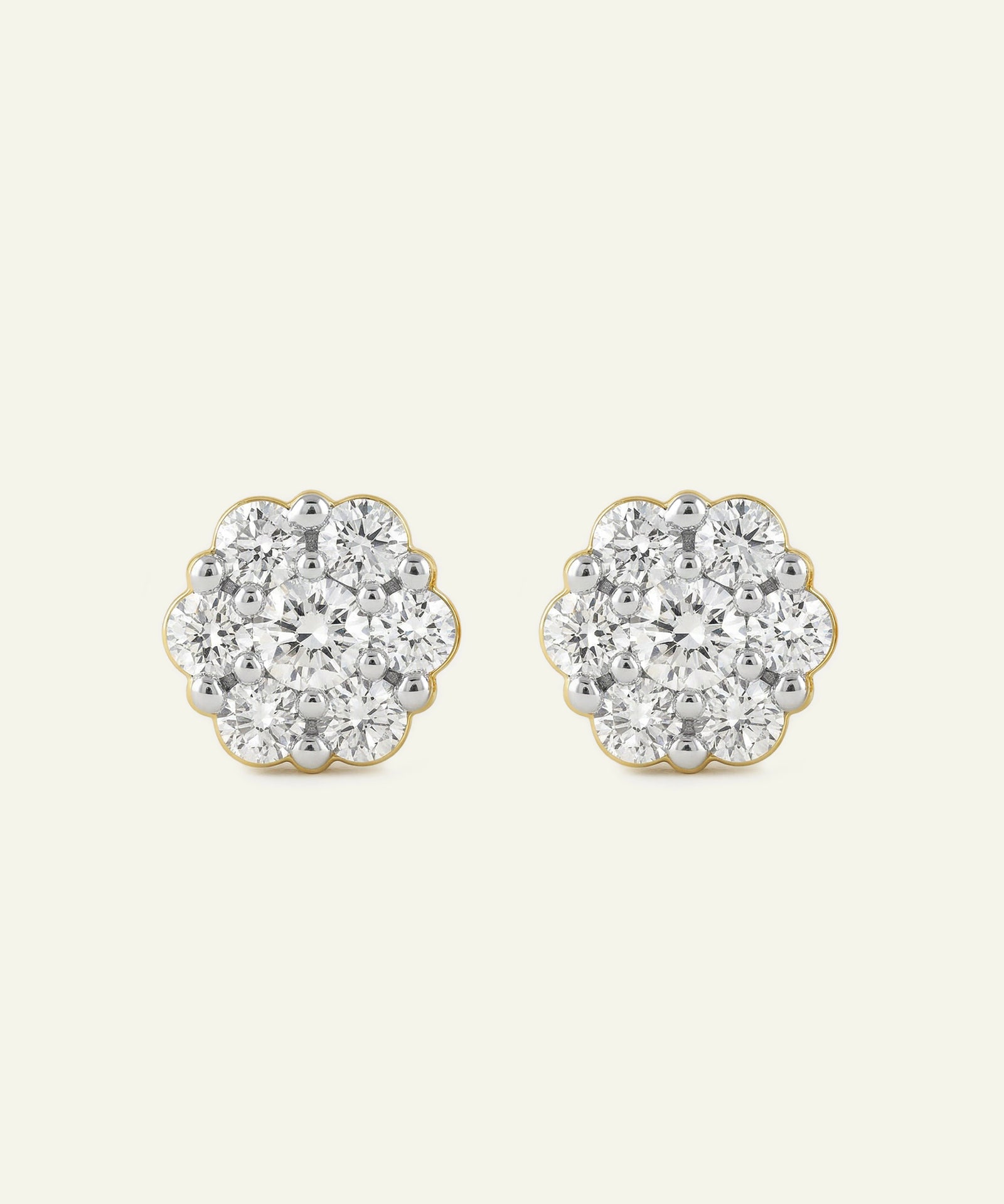 Pair of diamond stud earrings on a light gray background