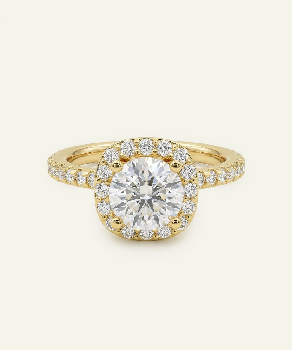 Gold ring with a large diamond and smaller diamonds around on a light beige background