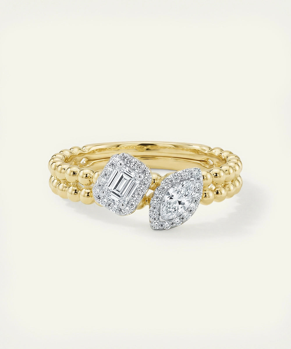 Two gold rings with diamond accents on a light background