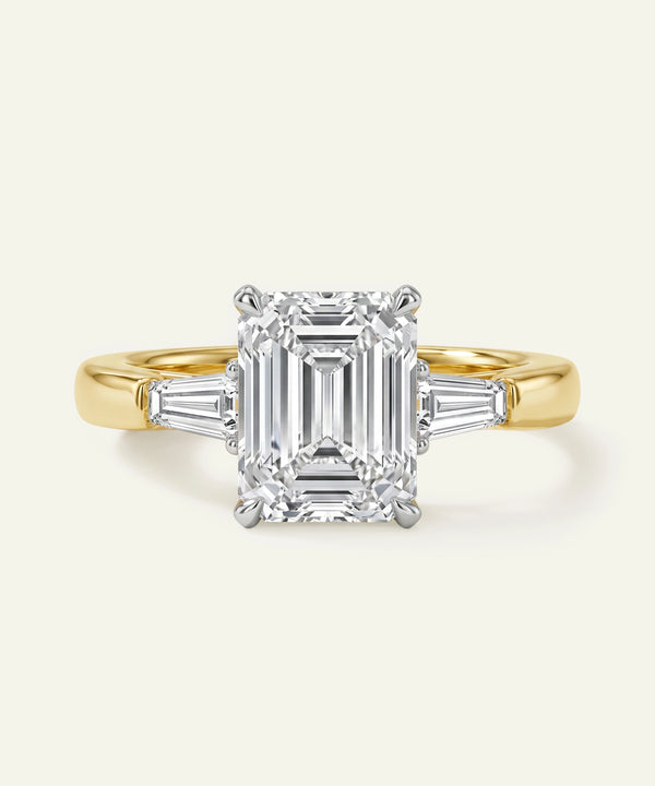 Gold ring with a diamond on a white background