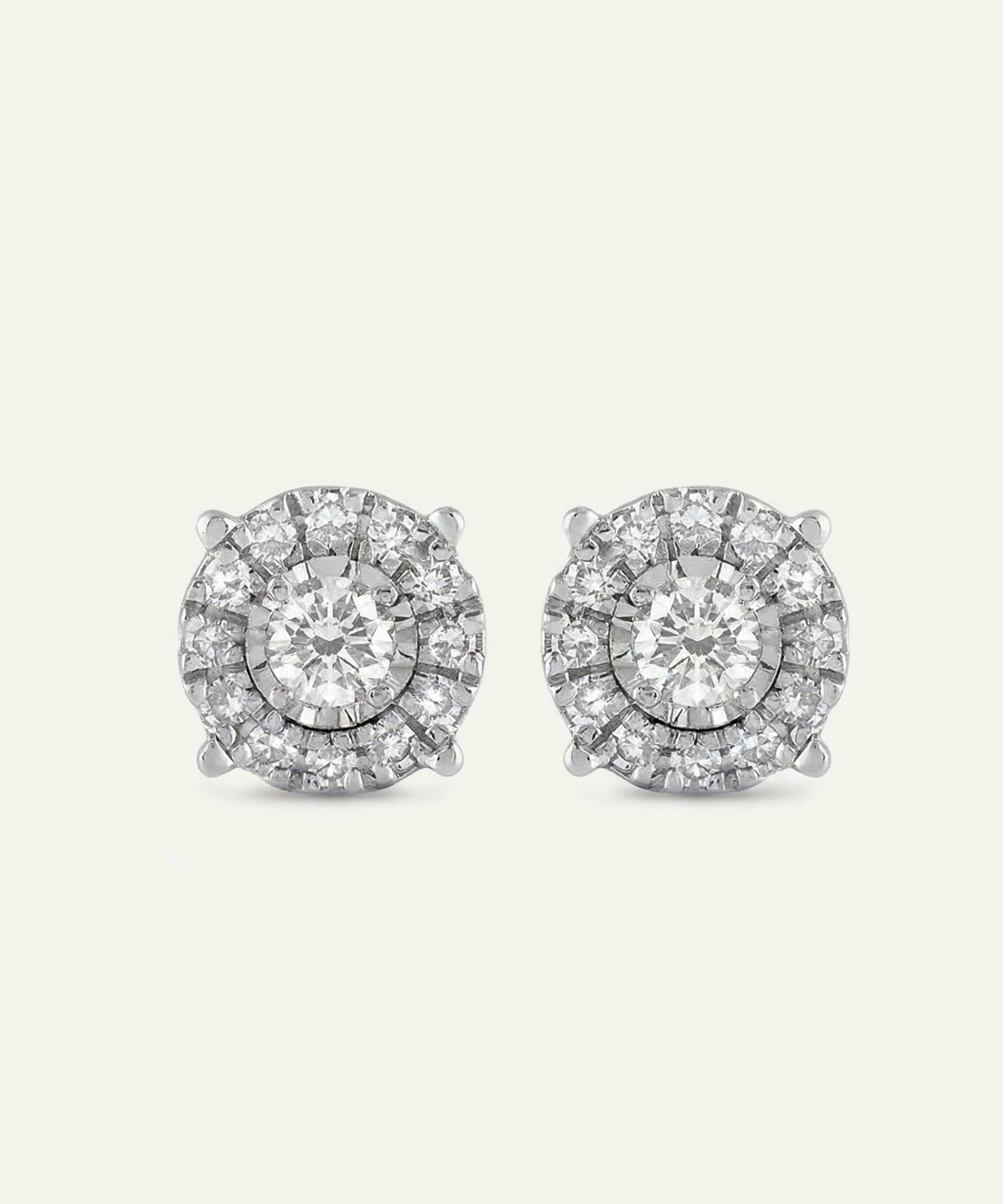 Pair of diamond stud earrings on a light gray background