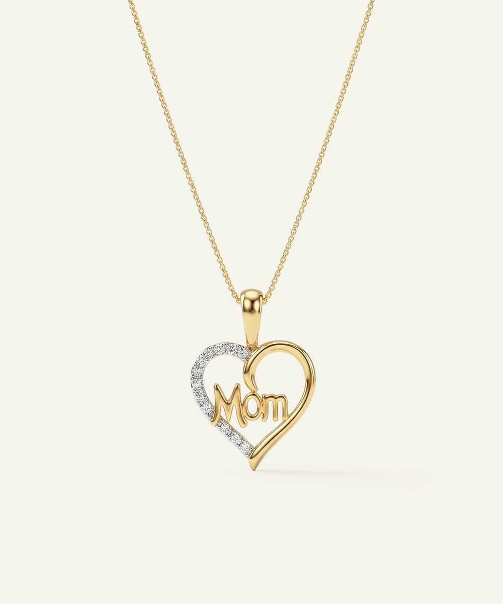 Gold heart-shaped pendant with 'Mom' engraving on a white background