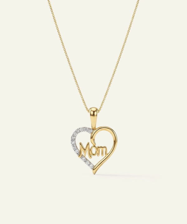 Gold heart-shaped pendant with 'Mom' engraving on a white background