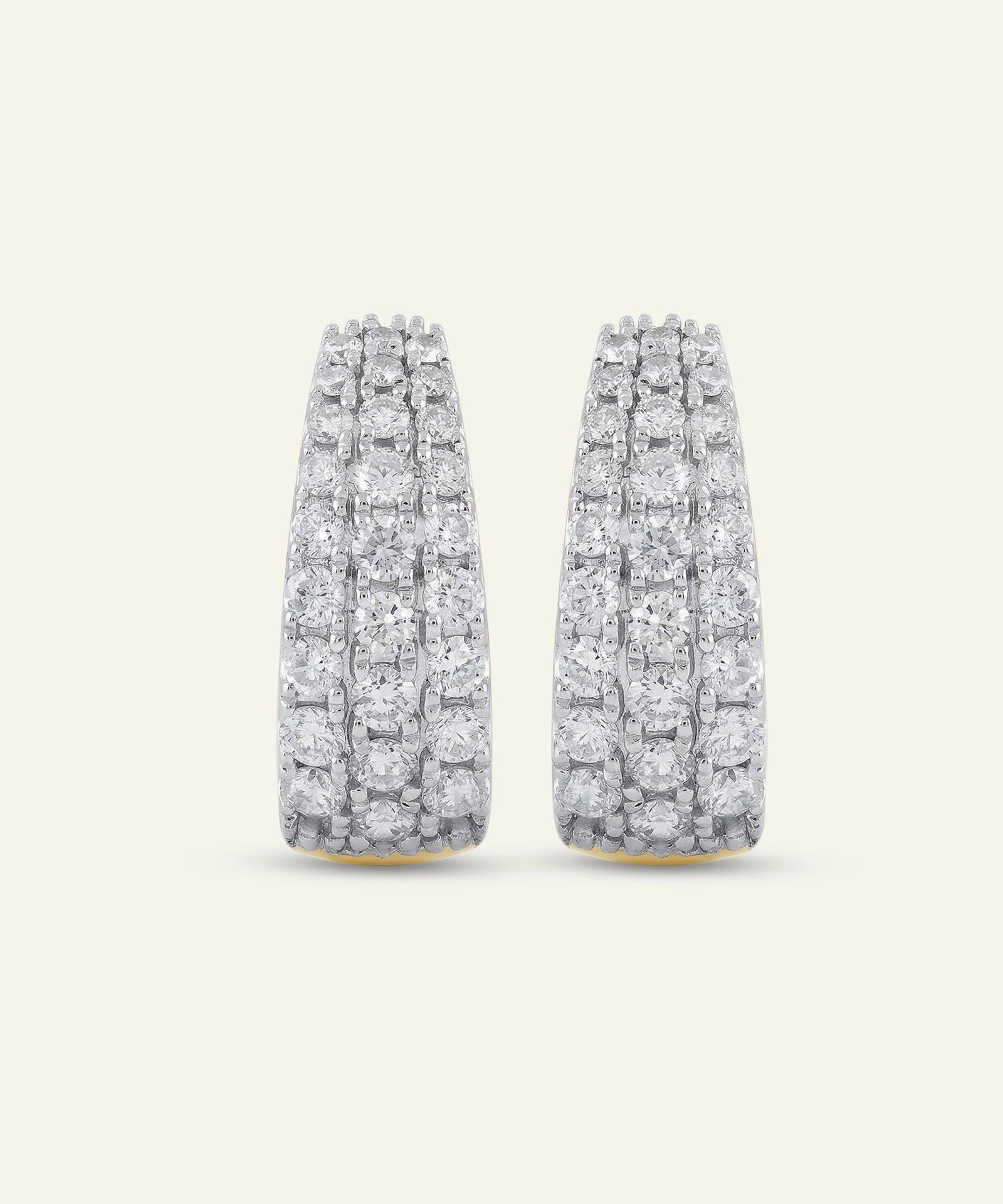Pair of diamond earrings on a light gray background