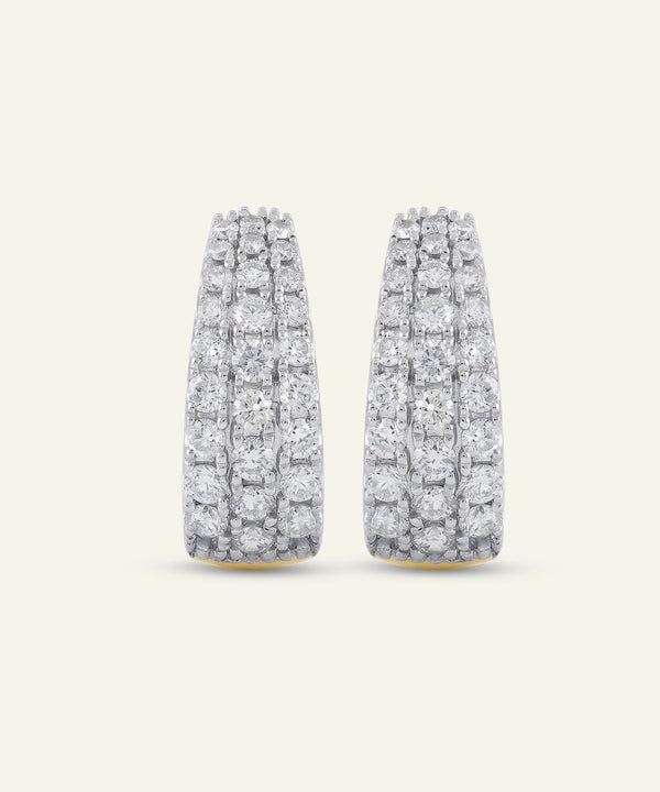 Pair of diamond earrings on a light gray background