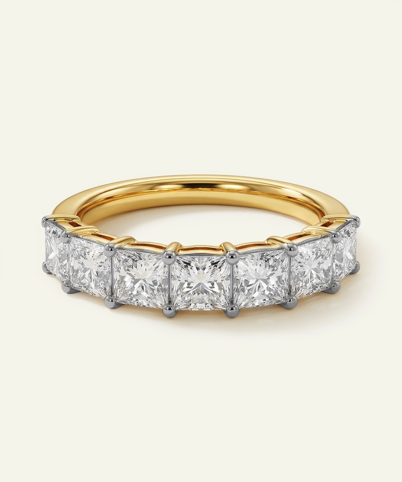 Gold ring with diamond stones on a light beige background