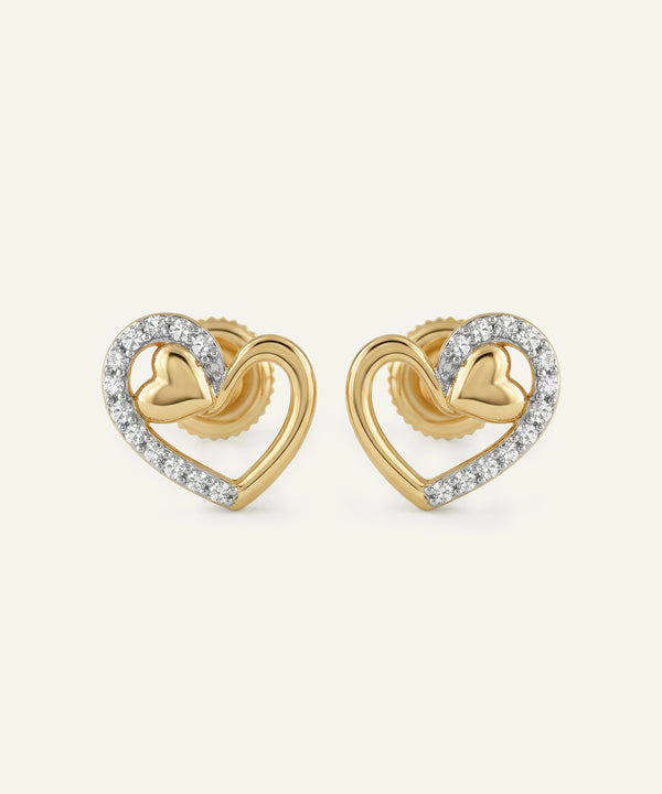 Gold heart-shaped earrings with diamond accents on a white background