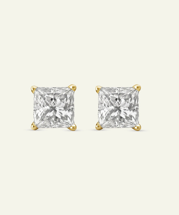 Pair of gold square-cut stud earrings on a white background
