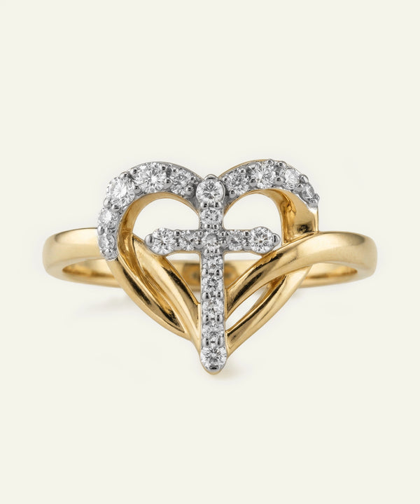 Gold ring with heart design and embedded diamonds on a white background