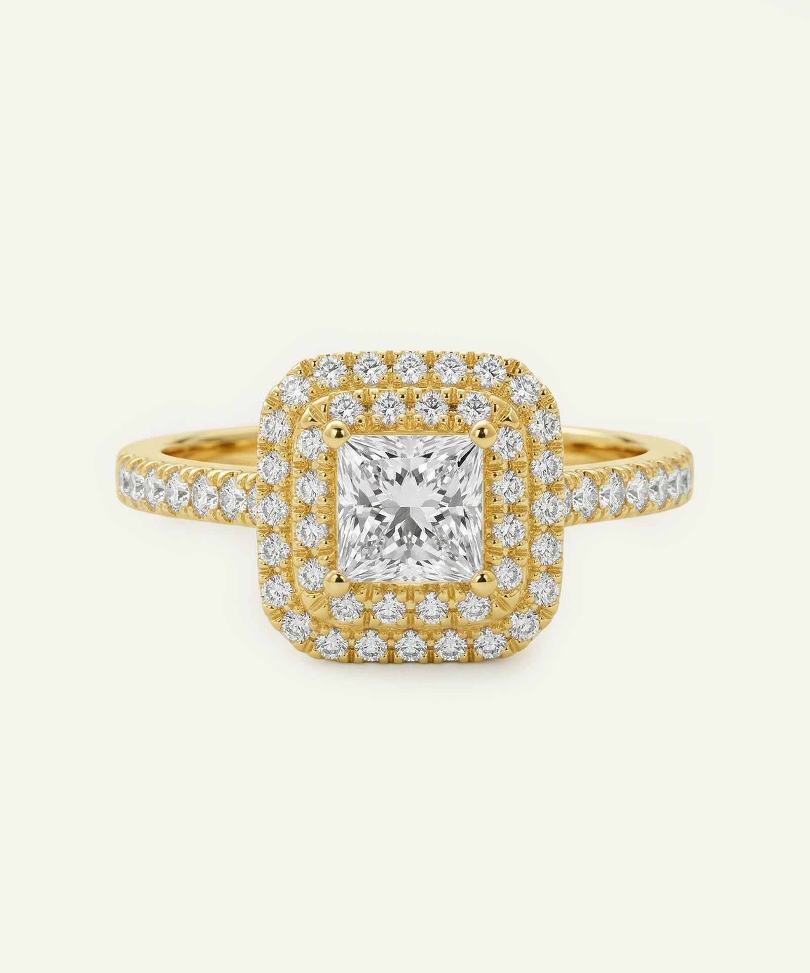 Gold ring with a large diamond and smaller diamonds on a white background