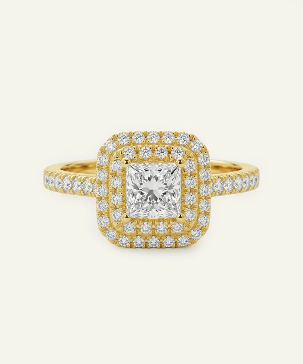 Gold ring with a large diamond and smaller diamonds on a white background